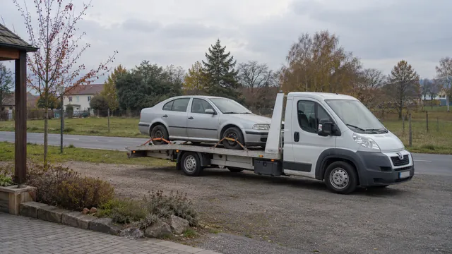 Bílý odtahový vůz s upevněným vozidlem Škoda na hliníkové plošině